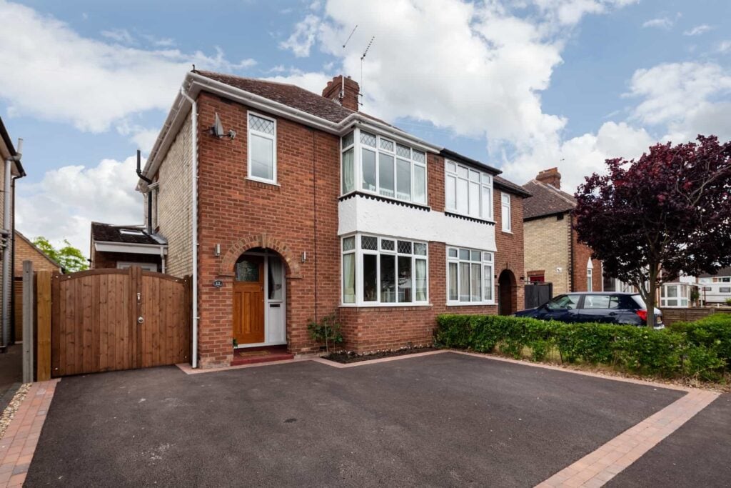 Smooth tarmac driveway with paved edging at a UK home
