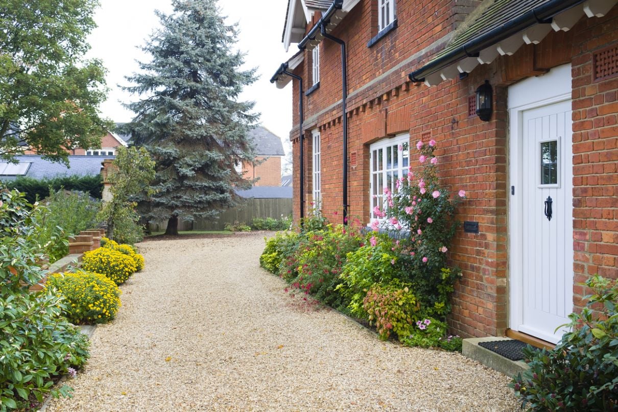 Gravel driveway with neat edging at a traditional home